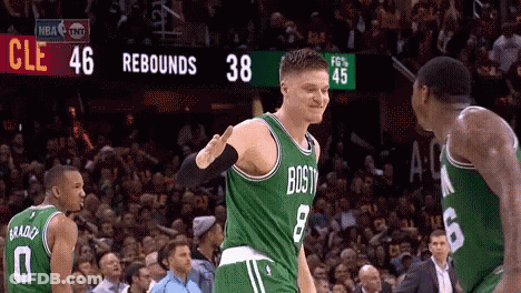 A Basketball Player Wearing A Green Jersey That Says Boston Is Giving Another Player A High Five GIF