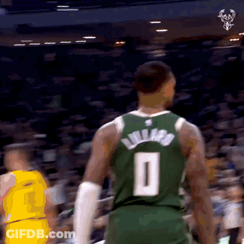 A Basketball Player Wearing A Green Jersey With The Number 0 On It GIF
