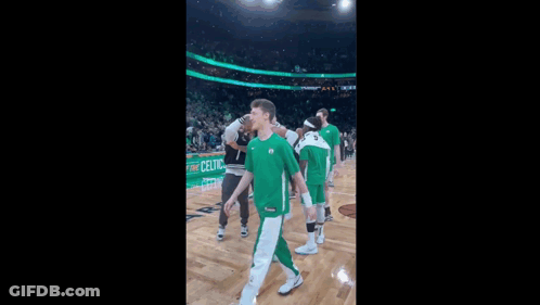 A Basketball Player Wearing A Green Jersey With The Number 26 GIF