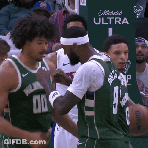 A Basketball Player Wearing A Green Jersey With The Number 9 On It GIF
