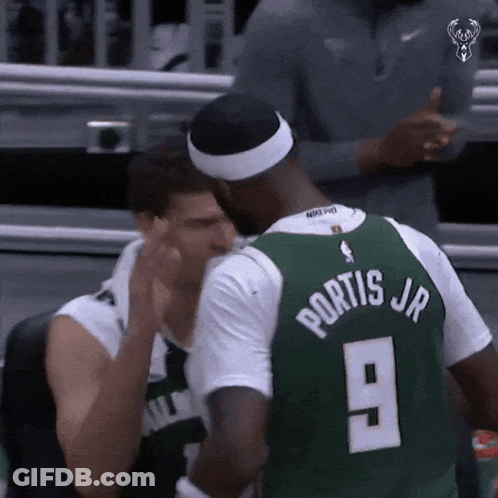 A Basketball Player Wearing A Green Jersey With The Number 9 On The Back GIF