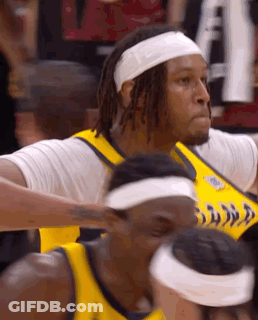 A Basketball Player Wearing A Headband And A Yellow Jersey GIF
