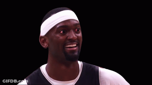 A Basketball Player Wearing A Headband And Smiling With Red Eyes GIF