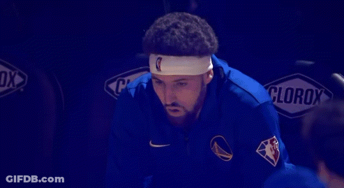 A Basketball Player Wearing A Headband Is Sitting In The Stands With His Mouth Open . GIF