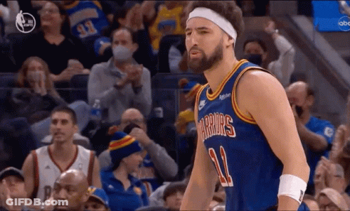 A Basketball Player Wearing A Headband Is Standing In Front Of A Crowd At A Basketball Game . GIF