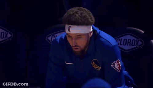 A Basketball Player Wearing A Headband With The Letter C On It Is Sitting In The Bleachers . GIF