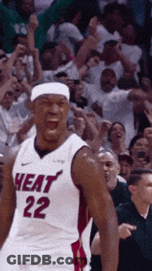A Basketball Player Wearing A Heat 22 Jersey Is Standing In Front Of A Crowd GIF