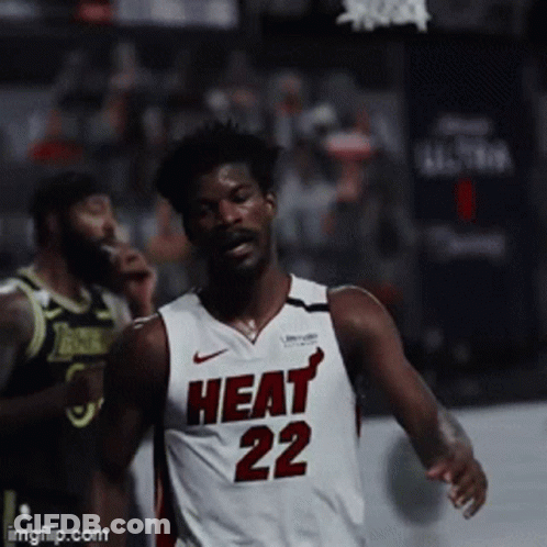 A Basketball Player Wearing A Heat 22 Jersey Runs On The Court GIF