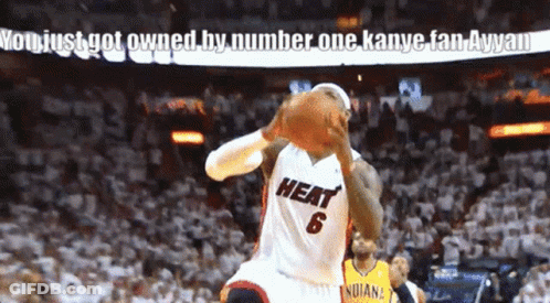 A Basketball Player Wearing A Heat Jersey Holds A Basketball GIF