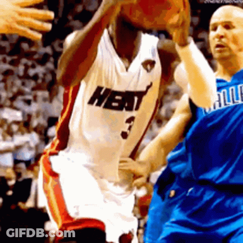 A Basketball Player Wearing A Heat Jersey Is Dribbling The Basketball GIF
