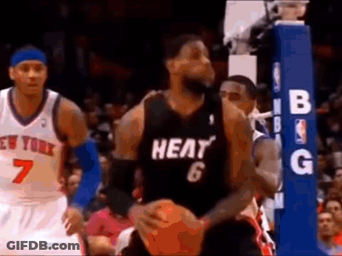 A Basketball Player Wearing A Heat Jersey Is Holding A Basketball While Playing Basketball . GIF