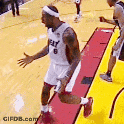 A Basketball Player Wearing A Heat Jersey Is Jumping On The Court GIF