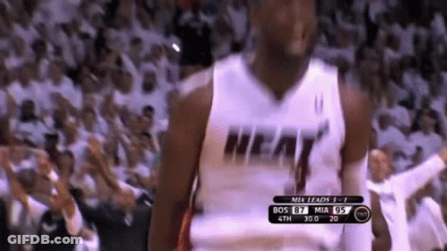 A Basketball Player Wearing A Heat Jersey Is Standing In Front Of A Crowd GIF