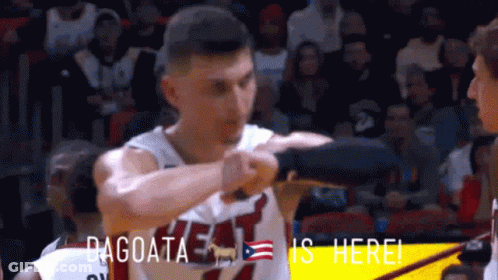 A Basketball Player Wearing A Heat Jersey Is Standing In Front Of A Crowd GIF