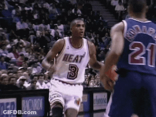 A Basketball Player Wearing A Heat Jersey Runs Towards Another Player Wearing A Number 21 Jersey GIF