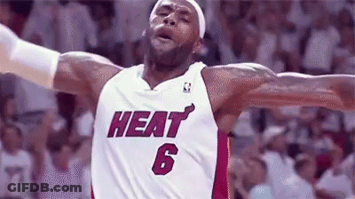 A Basketball Player Wearing A Heat Jersey With His Arms Outstretched GIF