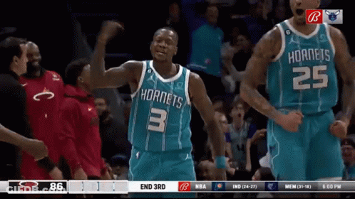 A Basketball Player Wearing A Hornets Jersey Celebrates During A Game GIF