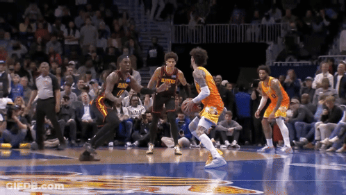 A Basketball Player Wearing A Jersey That Says Hawks Is Dribbling The Ball GIF