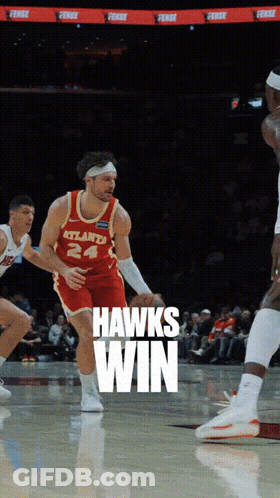 A Basketball Player Wearing A Jersey That Says Hawks Win GIF