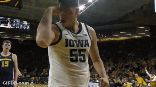 A Basketball Player Wearing A Jersey That Says Iowa On It GIF