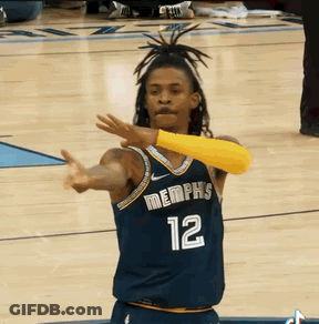 A Basketball Player Wearing A Jersey That Says Memphis 12 GIF