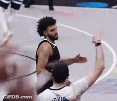 A Basketball Player Wearing A Jersey That Says Oklahoma Is Hugging Another Player GIF
