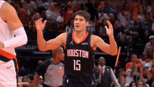 A Basketball Player Wearing A Jersey With The Number 15 On It Is Celebrating During A Game . GIF