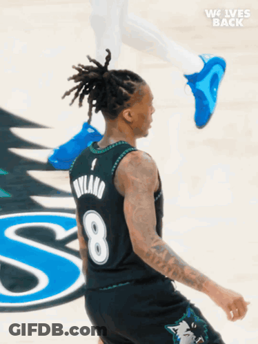 A Basketball Player Wearing A Jersey With The Number 8 GIF