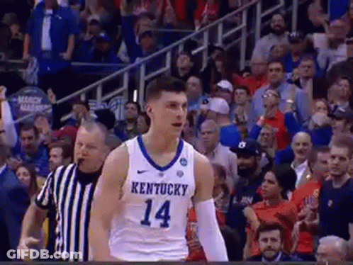 A Basketball Player Wearing A Kentucky Jersey Is Standing On The Court . GIF