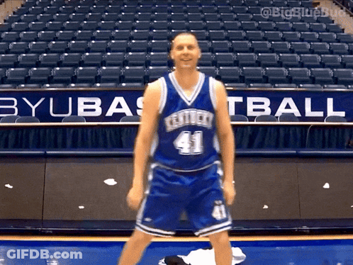 A Basketball Player Wearing A Kentucky Jersey Number 41 Stands In Front Of An Empty Stadium GIF