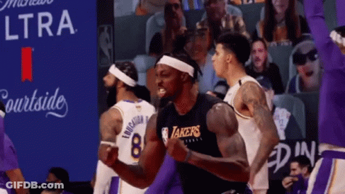 A Basketball Player Wearing A Lakers Jersey Celebrates In Front Of A Crowd GIF