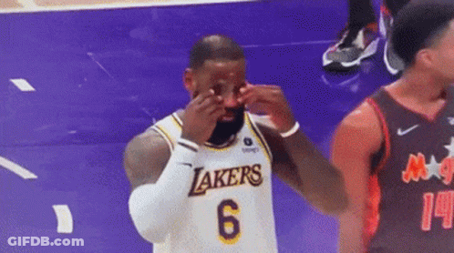 A Basketball Player Wearing A Lakers Jersey Is Crying On The Court During A Game . GIF