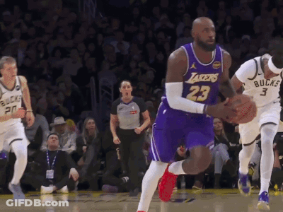A Basketball Player Wearing A Lakers Jersey Is Dribbling The Ball GIF