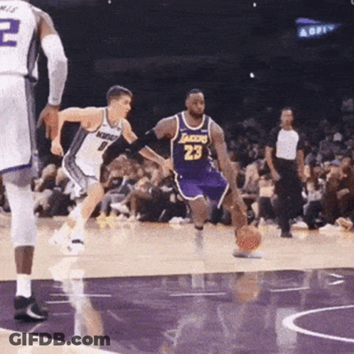 A Basketball Player Wearing A Lakers Jersey Is Dribbling The Ball GIF
