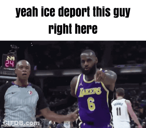 A Basketball Player Wearing A Lakers Jersey Is Pointing At A Referee GIF
