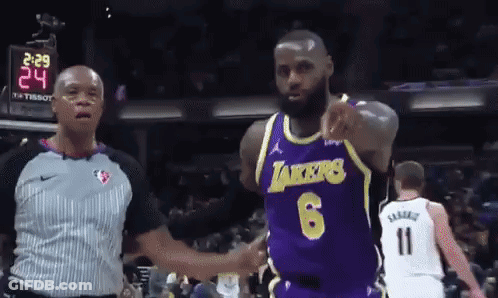 A Basketball Player Wearing A Lakers Jersey Is Pointing At The Referee GIF