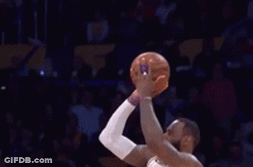 A Basketball Player Wearing A Lakers Jersey Is Standing In Front Of A Crowd . GIF