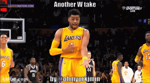 A Basketball Player Wearing A Lakers Jersey Is Standing In Front Of A Crowd GIF