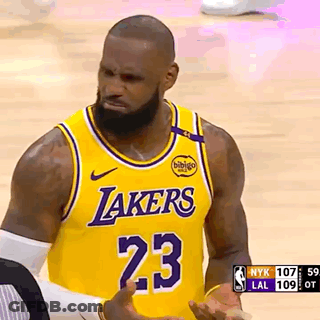 A Basketball Player Wearing A Lakers Jersey Is Talking To A Referee . GIF