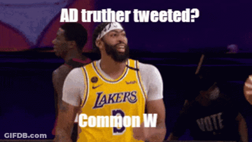 A Basketball Player Wearing A Lakers Jersey Stands In Front Of A Sign That Says Ad Truther Tweeted GIF
