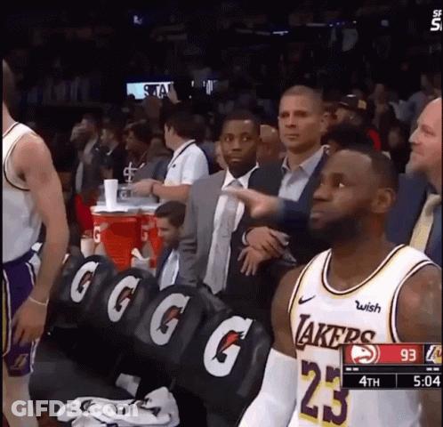A Basketball Player Wearing A Lakers Jersey Stands In The Stands During A Game GIF