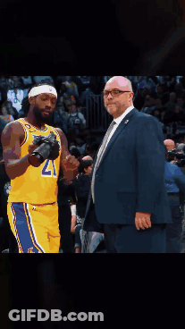 A Basketball Player Wearing A Lakers Jersey Stands Next To A Man In A Suit GIF