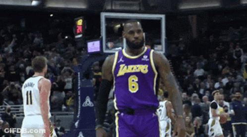 A Basketball Player Wearing A Lakers Jersey Stands On The Court GIF