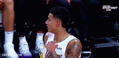 A Basketball Player Wearing A Lakers Jersey With A Wish Logo On His Chest GIF