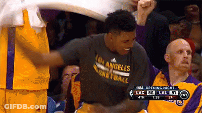 A Basketball Player Wearing A Los Angeles Basketball Shirt Is Being Congratulated By His Teammates GIF