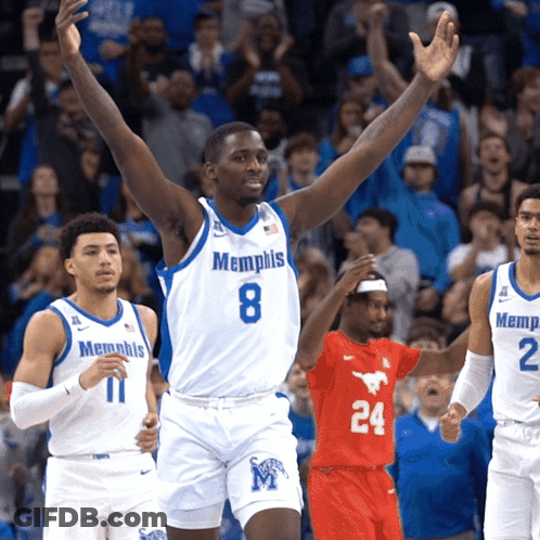 A Basketball Player Wearing A Memphis Jersey Stands With His Arms In The Air GIF
