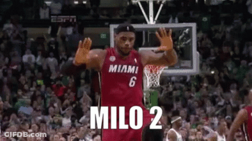 A Basketball Player Wearing A Miami Jersey Is Waving His Hands In The Air . GIF