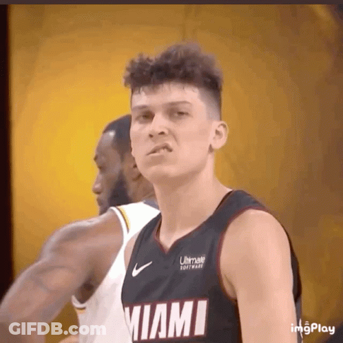 A Basketball Player Wearing A Miami Jersey Looks At The Camera GIF