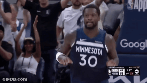 A Basketball Player Wearing A Minnesota 30 Jersey Stands In Front Of A Crowd GIF