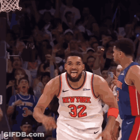 A Basketball Player Wearing A New York 32 Jersey Stands In Front Of A Crowd GIF